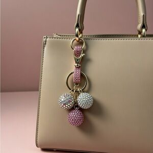 Beige Handbag with Pink and White Crystal Keychain